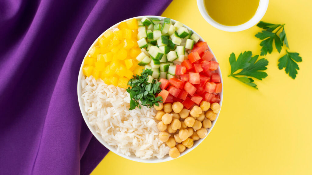 Salad bowl with Rice, cucumber, tomatoes, yellow bell peppers and chickpeas