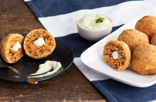 Fried rice croquettes filled with chorizo cream cheese with avocado cream