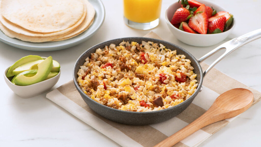 Served on a pan, chorizo and rice breakfast scramble with tomatoes