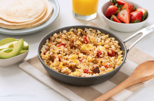 Served on a pan, chorizo and rice breakfast scramble with tomatoes