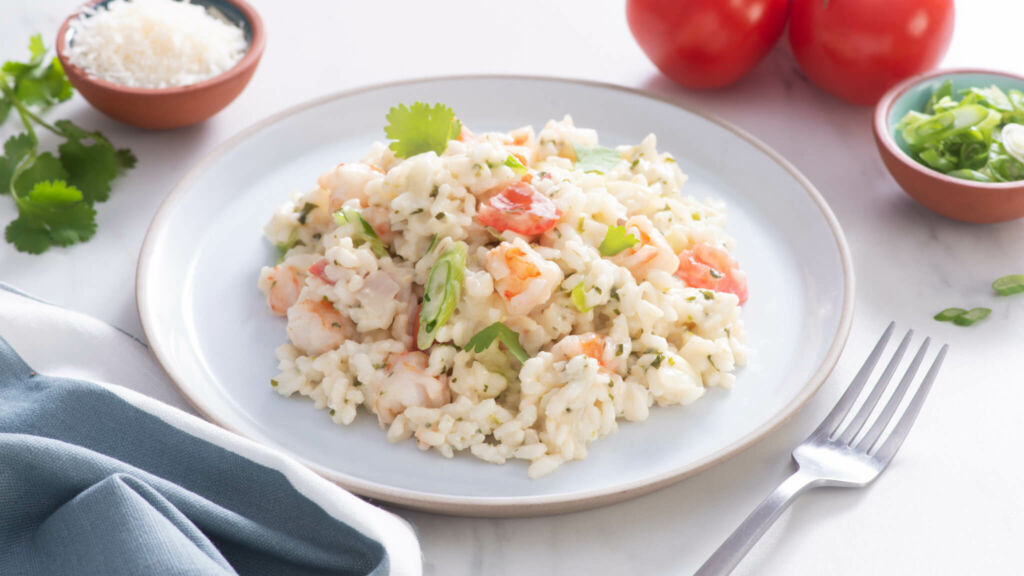 White plate with cilantro and shrimp creamy risotto