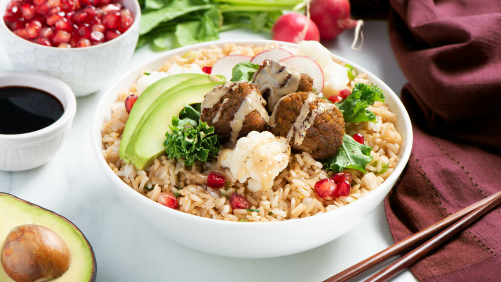 Power bowl with fried rice, falafel, tahini sauce, an avocado and soy sauce