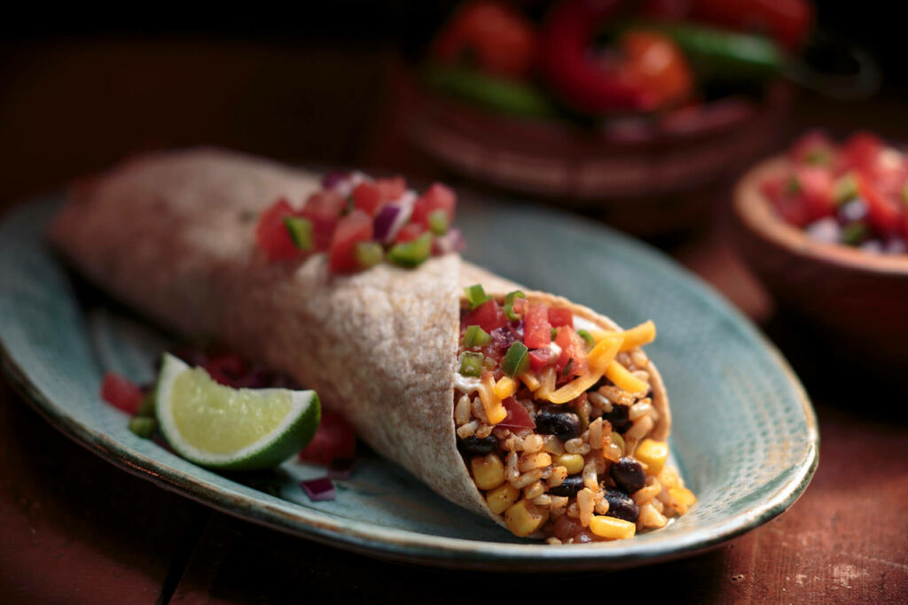 Mexican burrito with brown rice, black beans and a lime slice