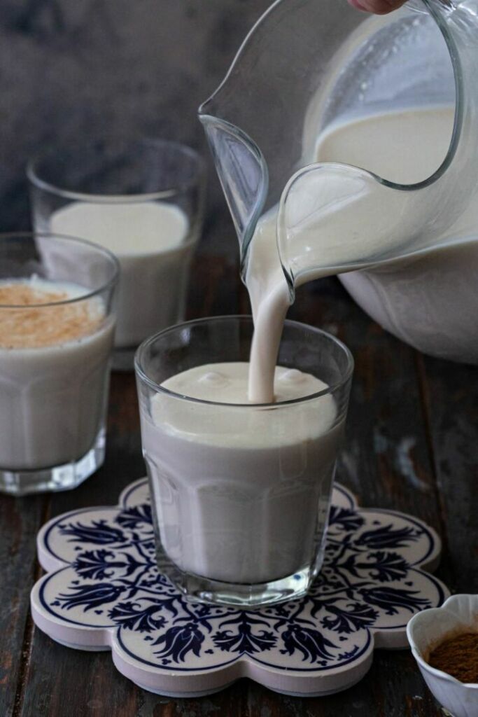 pouring horchata into a glass