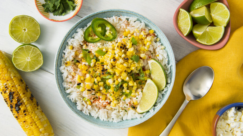 mexican-grilled-street-corn-with-white-rice-jalapenos-and-lime-wedges