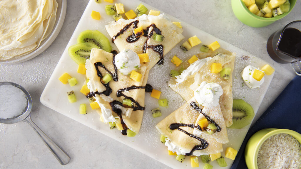 rice-crepes-with-kiwi-pineapples-mango-coconut-whipped-cream-and-chocolate-syrup